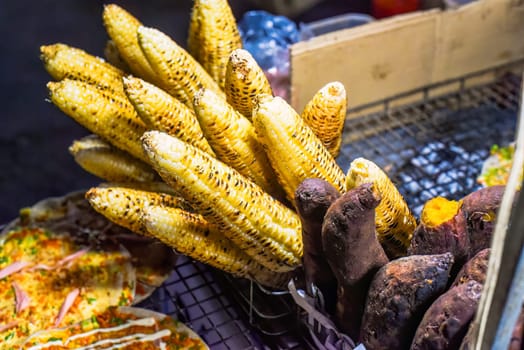 Grilled sweet potato and corn in vietnamese night market in Da Lat