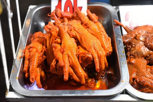 Vietnamese favorite snack braised chicken paw in chili sauce in vietnamese night market in Da Lat