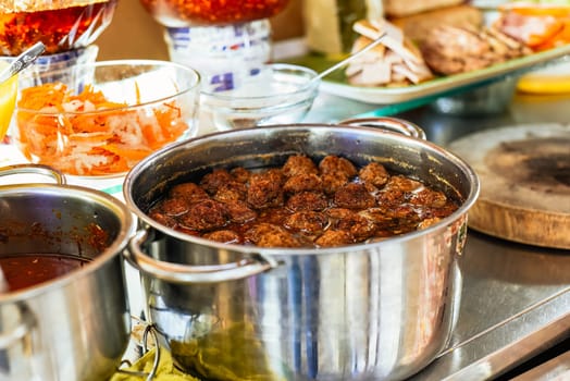 meatballs in asian sauce in a pot on street food in Vietnam