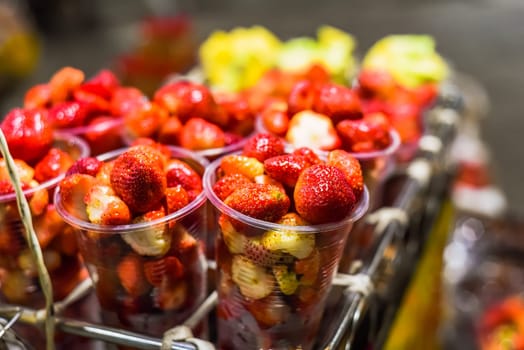 Many fresh natural strawberry and apple in vietnamese night market in Da Lat