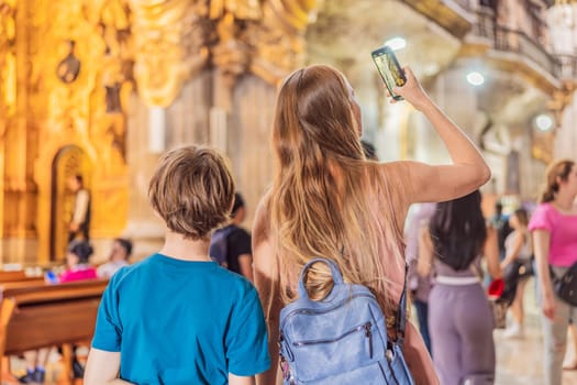 A woman and her son tourists exploring the Metropolitan Cathedral in Mexico City. Woman admiring the architecture and history of Mexico's iconic landmark. Concept of cultural heritage, religious tourism, and travel discovery.