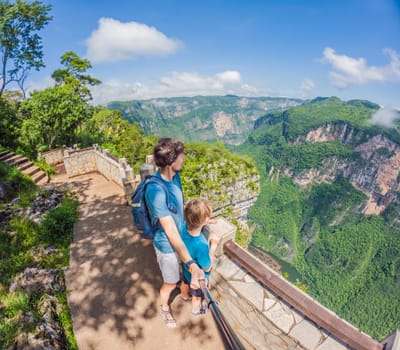 Father and son exploring Sumidero Canyon, Mexico. Family adventure in nature with breathtaking river views, towering cliffs, and lush scenery. Concept of bonding, outdoor exploration, and eco-tourism.
