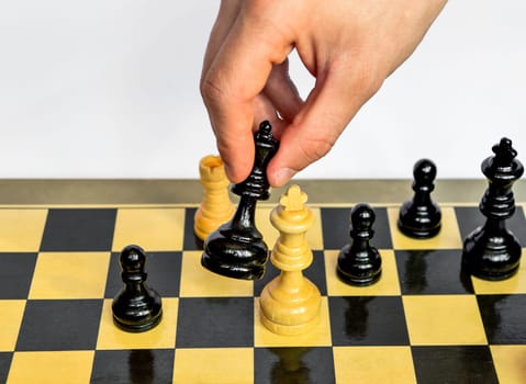 The white king is going to be defeated by the black queen in the male hand. Checkmate