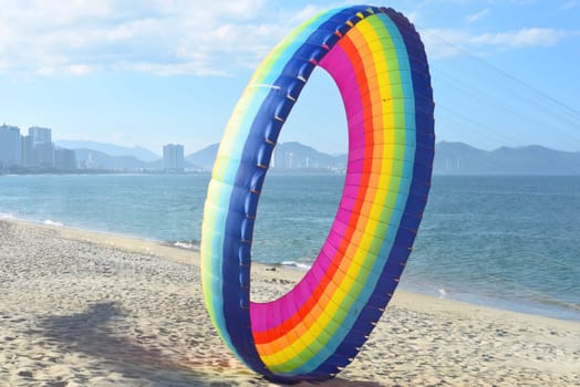 Rainbow kite on sandy beach in Vietnam