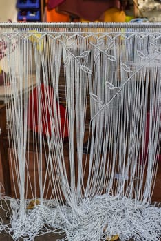 Example of simple leaves pattern knots of macrame technique made of white threads