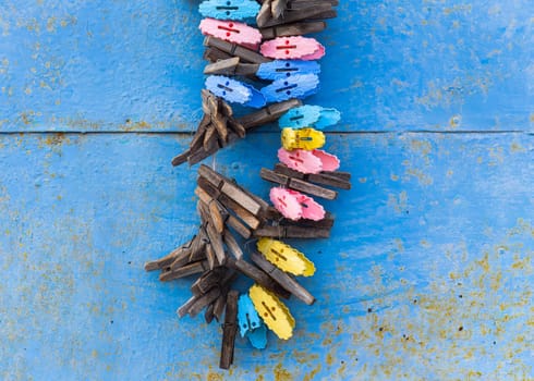 clothespins on a rope against shabby wall