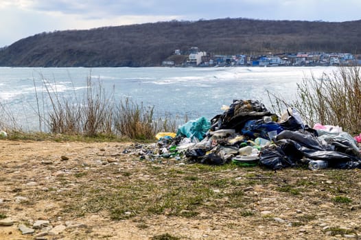 A pile of garbage left on the shore of the Sea of ​​Japan after people rest. environmental pollution concept