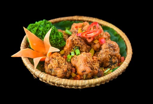 Vietnamese fried chicken meat on a natural leaf isolated for a menu