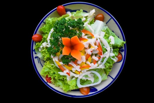 Fresh Vietnamese salad with vegetables on black background side view