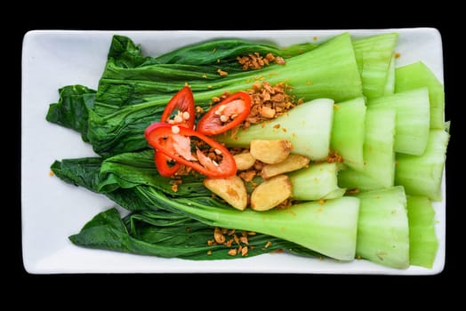 Vietnamese stir fried cabbage with garlic isolated on black background for a menu
