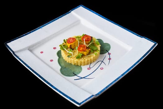 Vegetarian porridge quinoa with baked pumpkin and tomatoes isolated on black background