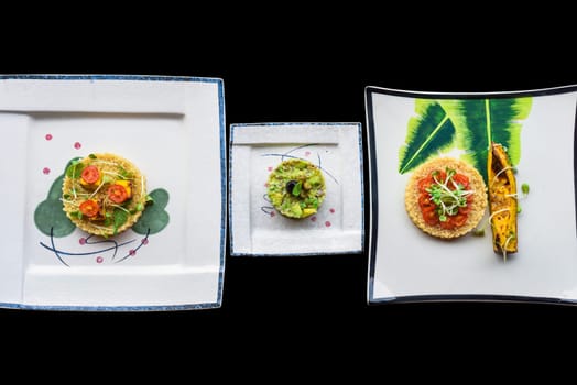 Vegetarian porridge quinoa with baked pumpkin and tomatoes and Vegetarian zucchini and avocado tartare with olive