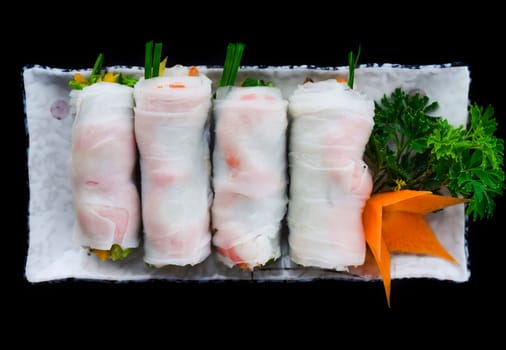 Vietnamese Pho spring roll with seafood, tofu, vegetables isolated on black background for a menu
