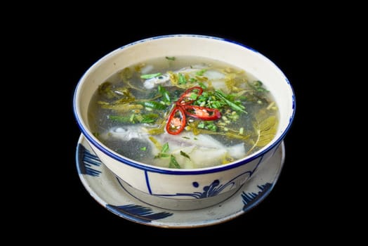 Canh Chua Ca or Vietnamese Sour Catfish Soup isolated on black background