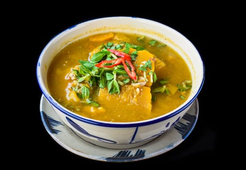 Vietnamese pumpkin Soup on black background
