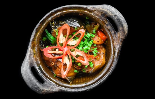 Vietnamese fried Mackerel fish with sauce on black background