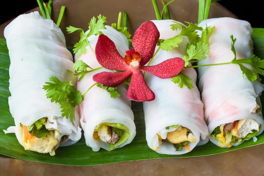 Vietnamese Pho spring roll with seafood, tofu, vegetables isolated on black background for a menu