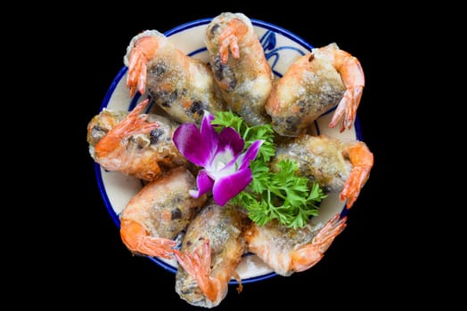 Traditional fried vietnamese spring rolls with shrimps and pork, rice paper on black background