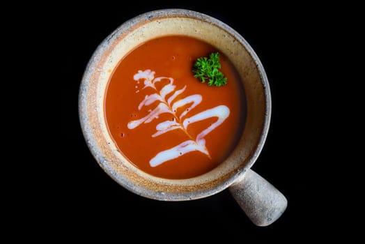 Tomato Cream Soup isolated on black background top view