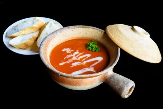 Tomato Cream Soup isolated on black background side view
