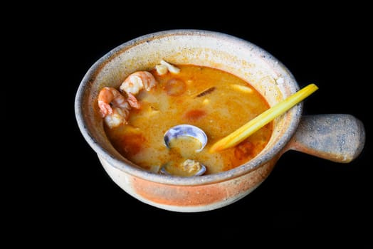 Soup tom yum with tomato and mussels top view