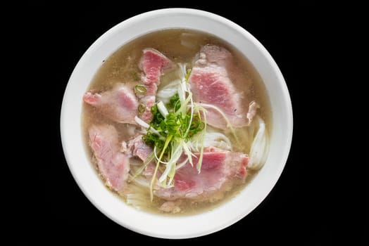 Traditional vietnamese soup Pho bo on black background
