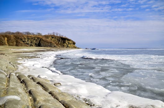 Frozen Japanese sea with floating ice on a winter day. Vladivostok, Russia