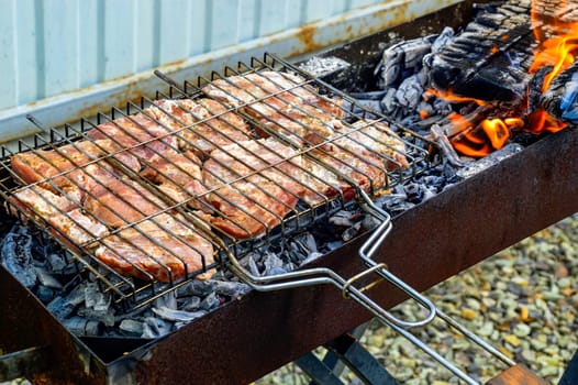 Marinated raw pork grilled on the grill. backyard cooking
