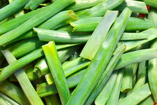 First fresh green onions chopped into pieces in a wicker basket