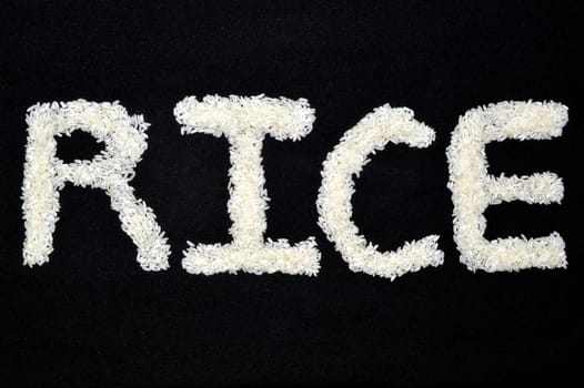Word arts "Rice" made of rice grain on black background