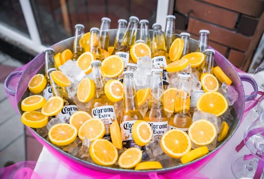 Vladivostok, Russia - 23 September 2024: many chilled bottles of Corona Extra beer in ice with lemon slices at a bachelorette party.