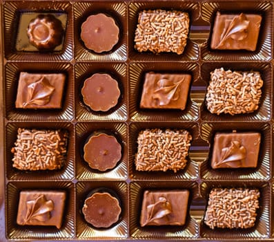 Box of different chocolate sweets close up