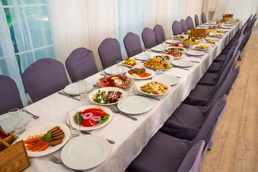 festive table set with Caesar salads, beets, fruit plate without people