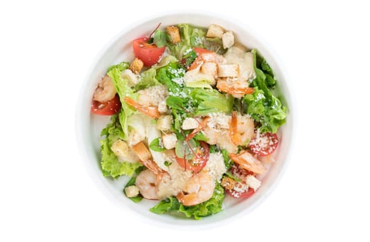 Caesar salad with shrimps on white background top view
