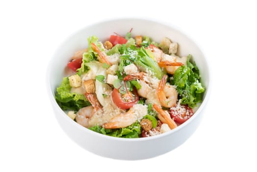 Caesar salad with shrimps on white background top view