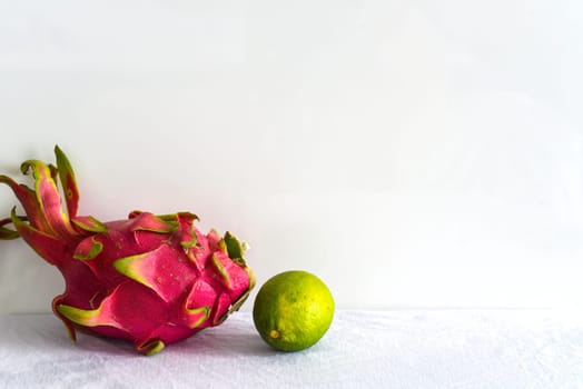 Pitaya or dragon fruit with lime on white background