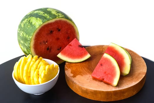 Sliced watermelon and pineapple on white background