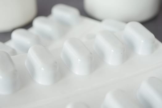 Close-up view of white pills on a surface.