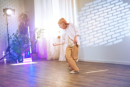 A dancer showcases their skill in a brightly-lit studio with creative lighting effects. Their movements convey emotion and artistry against a minimalist backdrop.