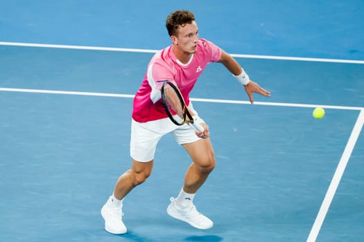 MELBOURNE, AUSTRALIA - JANUARY 19: Jiri Lehecka of Czech Republic hits a forehand to Novak Djokovic of Serbia on day eight of the 2025 Australian Open at Melbourne Park on January 19, 2025 in Melbourne, Australia.