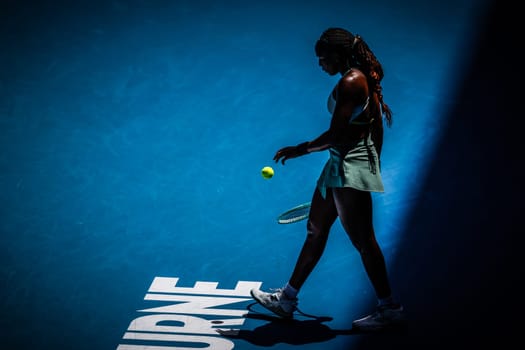 MELBOURNE, AUSTRALIA - JANUARY 19: Coco Gauff of USA serves to Belinda Bencic of Switzerland on day eight of the 2025 Australian Open at Melbourne Park on January 19, 2025 in Melbourne, Australia.