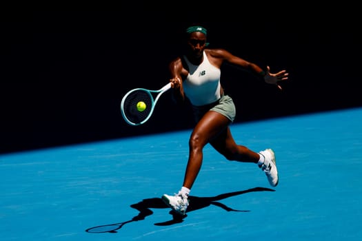 MELBOURNE, AUSTRALIA - JANUARY 19: Coco Gauff of USA hits a forehand to Belinda Bencic of Switzerland on day eight of the 2025 Australian Open at Melbourne Park on January 19, 2025 in Melbourne, Australia.