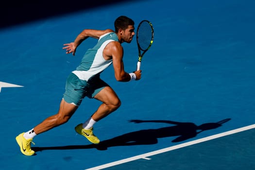 MELBOURNE, AUSTRALIA - JANUARY 19: Carlos Alcaraz of Spain runs to a ball whilst playing Jack Draper of Great Britain on day eight of the 2025 Australian Open at Melbourne Park on January 19, 2025 in Melbourne, Australia.