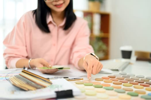 Creative interior designer working on a new project analyzing color palettes and material samples.