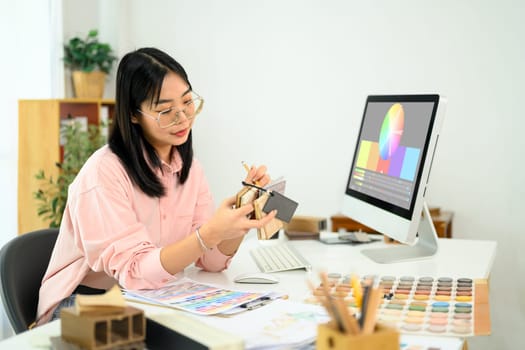 Female designer selecting colors and materials for an interior project.