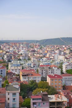 Overlooking a bustling neighborhood with diverse architecture and rooftops.