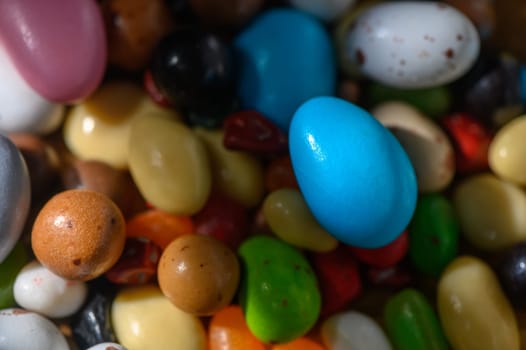 Brightly colored candy eggs scattered among assorted sweets, creating a joyful display perfect for spring festivities.