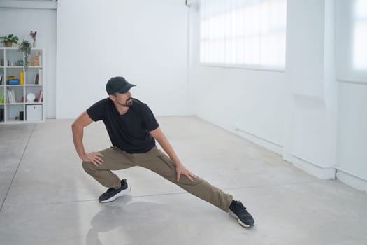 A talented dancer passionately showcases an array of dynamic moves within a spacious, modern studio setting