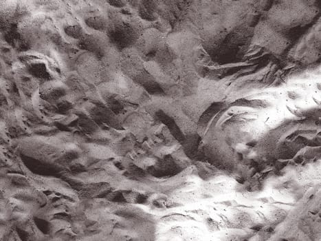 Background texture image of gray beach sand top view