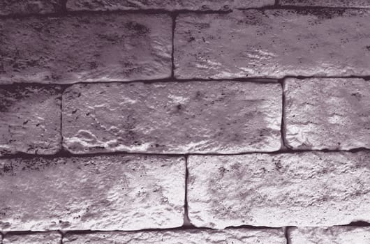 An old monochrome wall of blocks in close-up